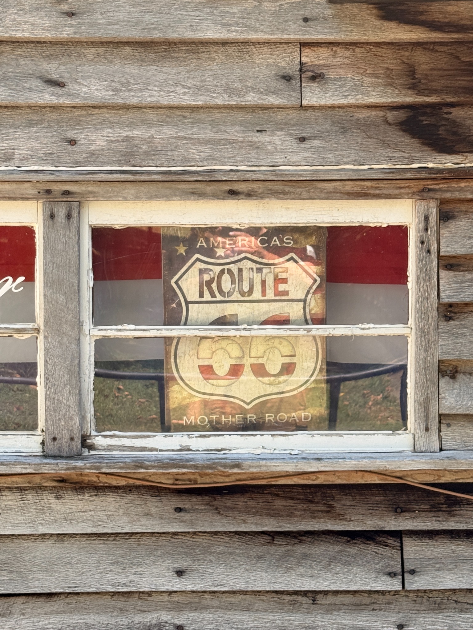 A Mother Road sign in the window of the Elbow Inn