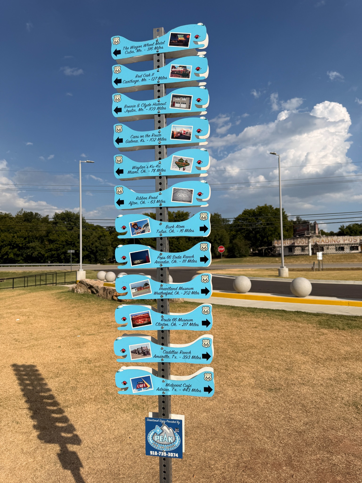 A whale-shaped signpost points toward Route 66 landmarks