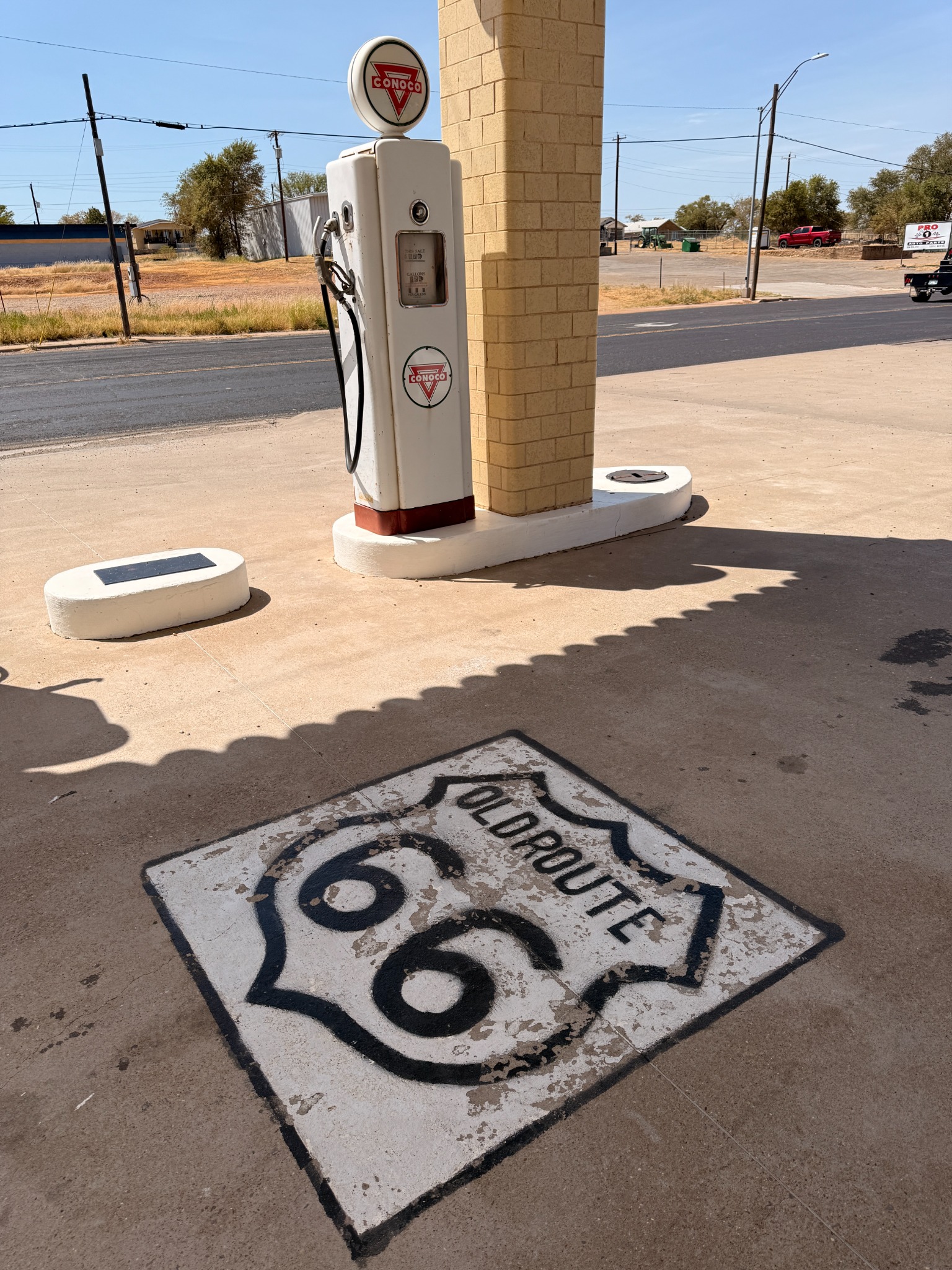 A vintage Conoco pump and Route 66 pavement shield.