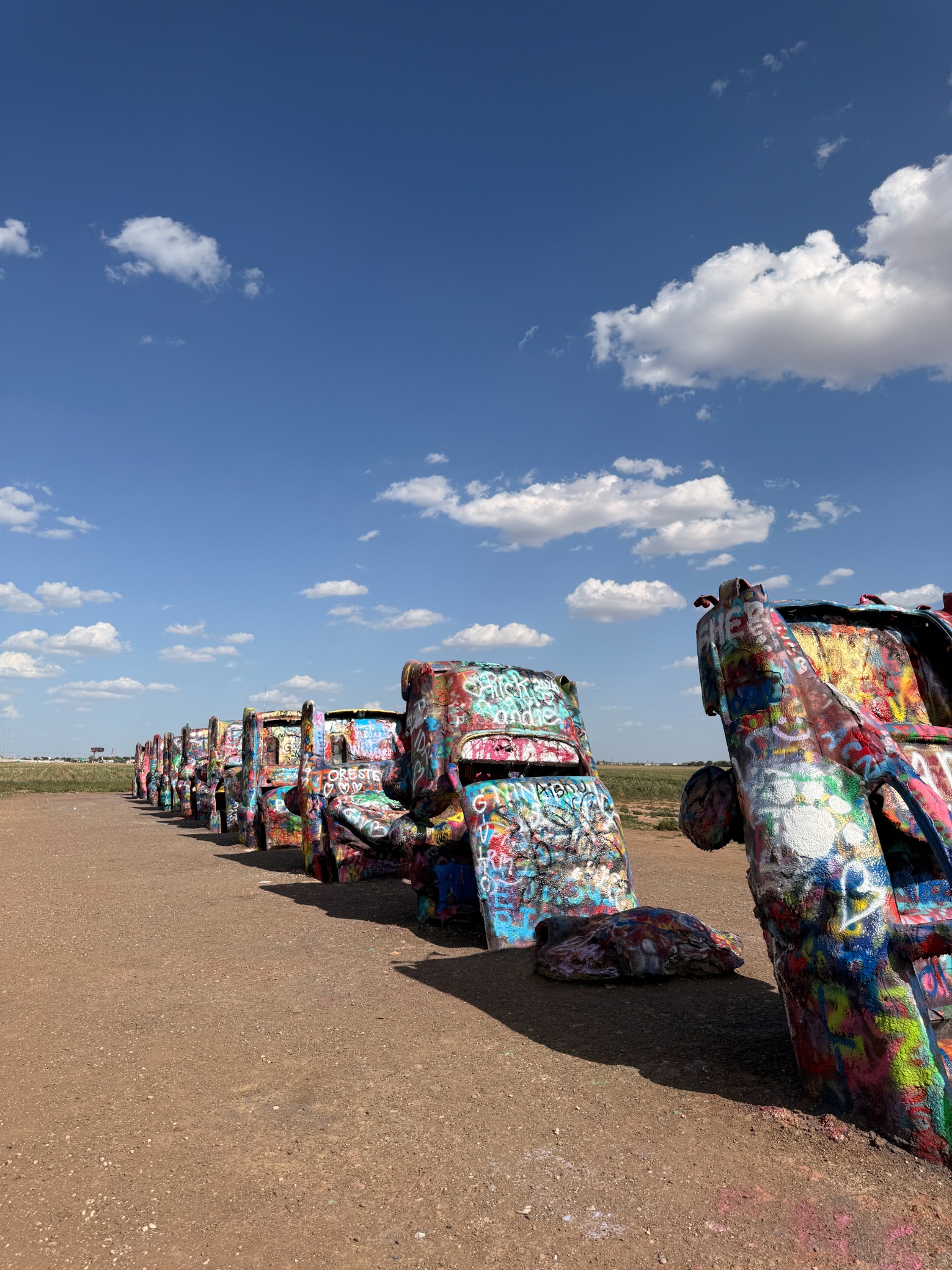 A row of buried Cadillacs beneath the wide Texas sky.
