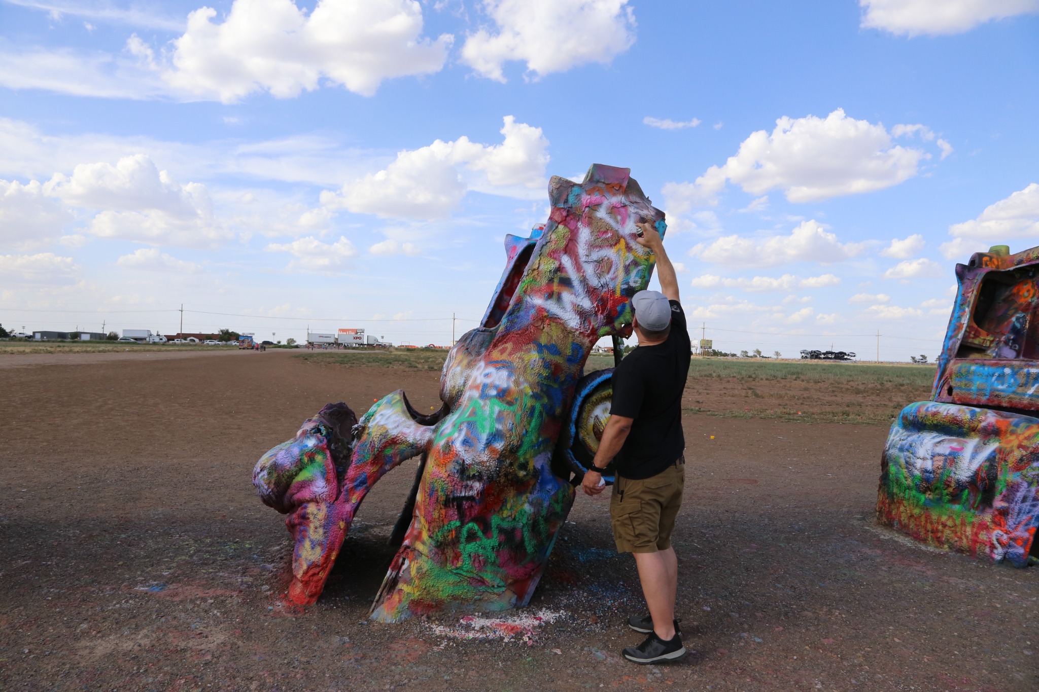 Mike adding our call signs at Cadillac Ranch.