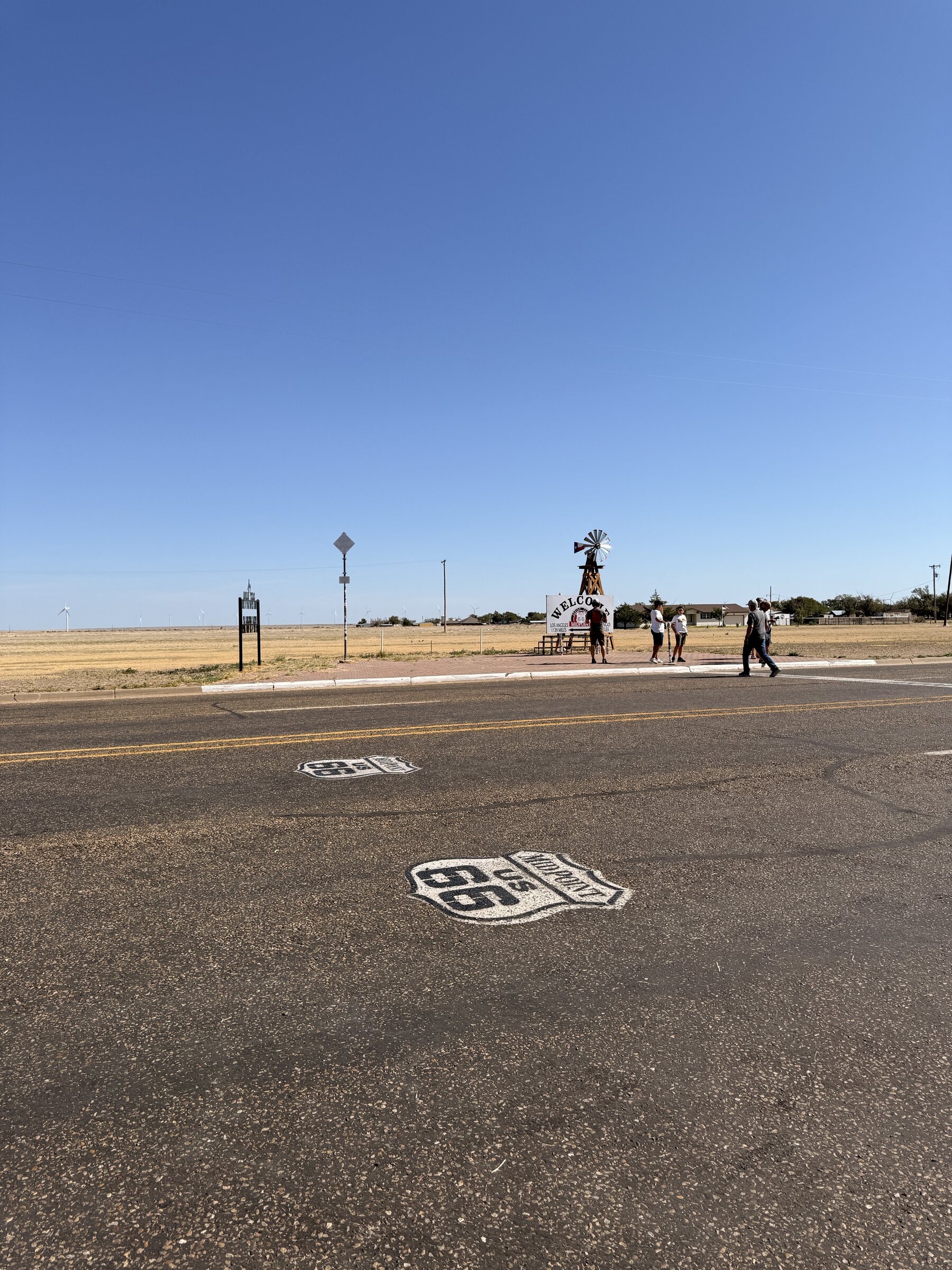 The Route 66 midpoint painted across the road in Adrian, Texas.
