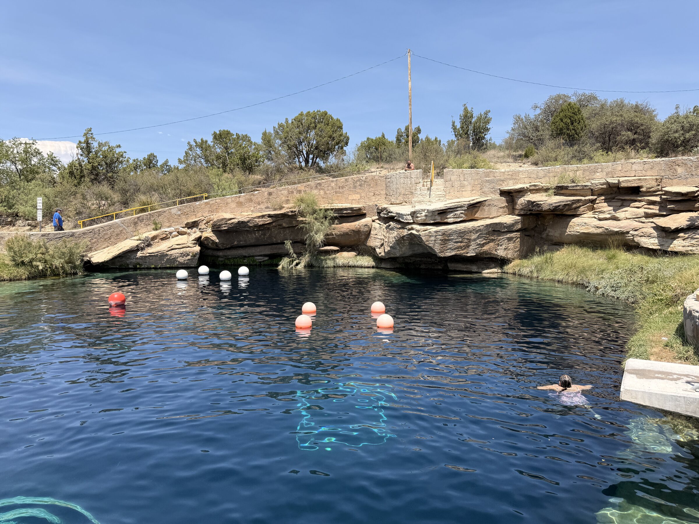 Swimmers enjoying the clear water at the Blue Hole in Santa Rosa.