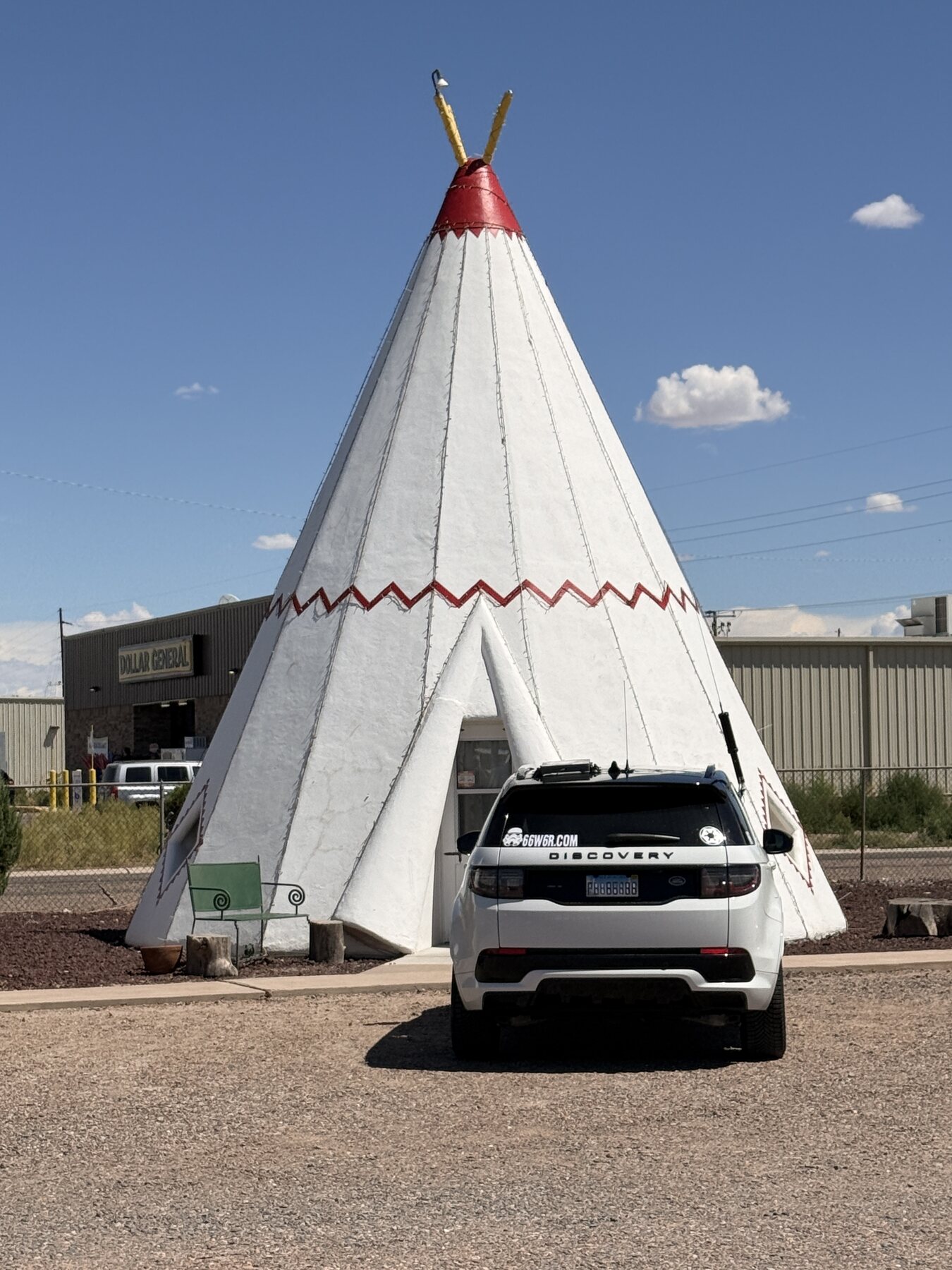 The expedition vehicle parked beside one of the motel’s concrete wigwams.