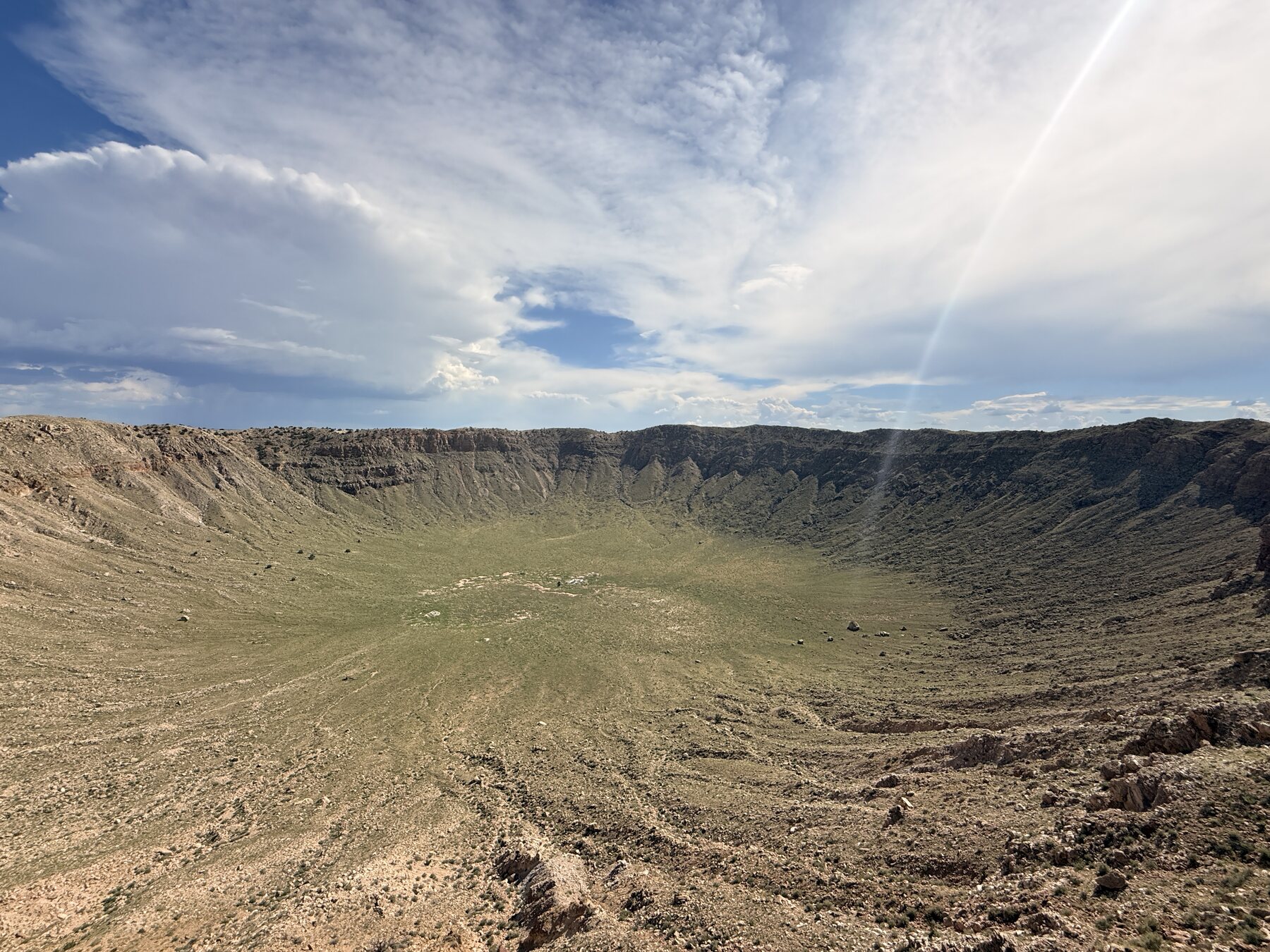 The enormous Meteor Crater beneath the high Arizona sky.