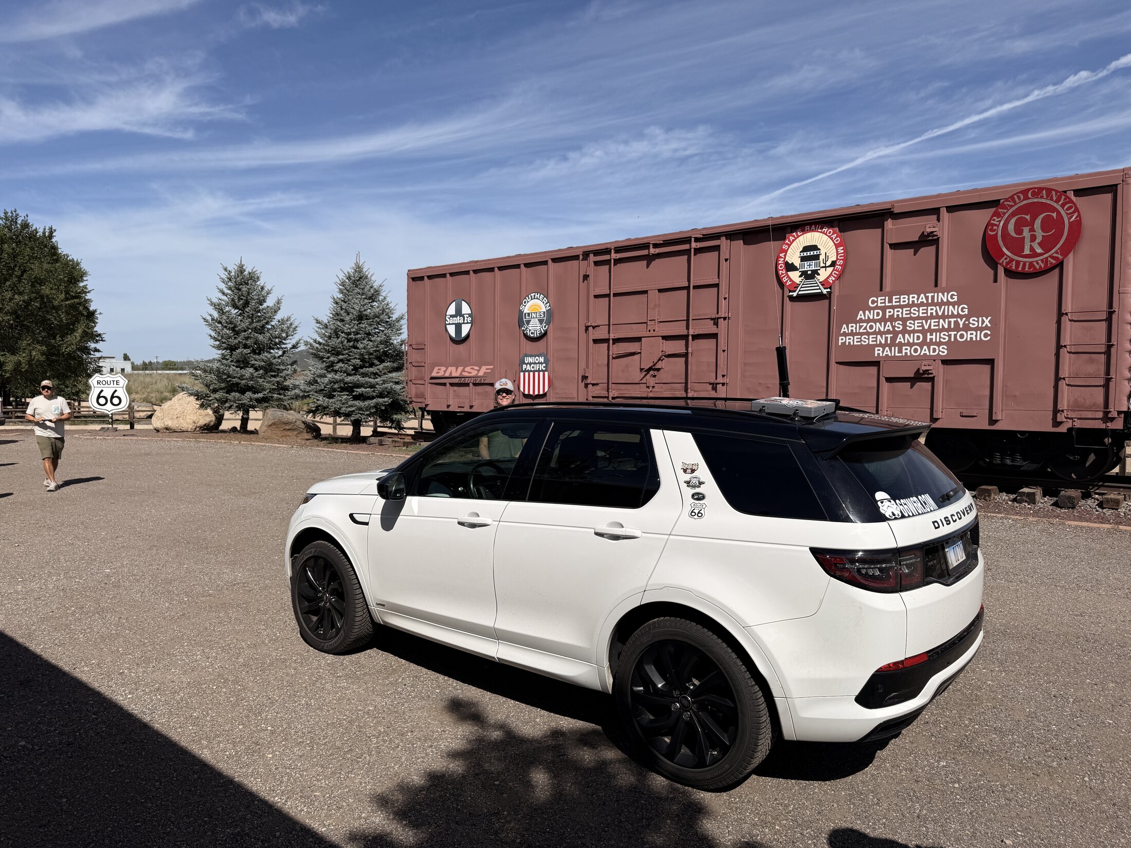 The expedition vehicle beside a Route 66 Centennial railcar in Williams.