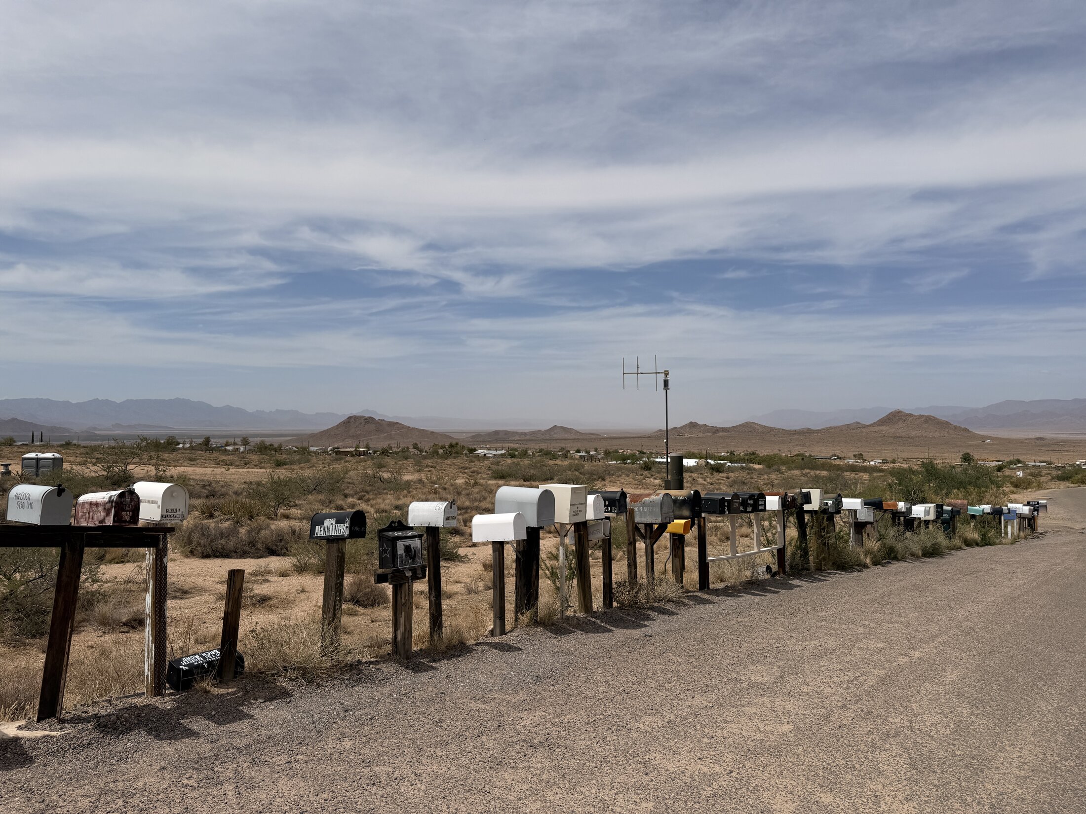 A long line of mailboxes beside a quiet stretch of the Mother Road.
