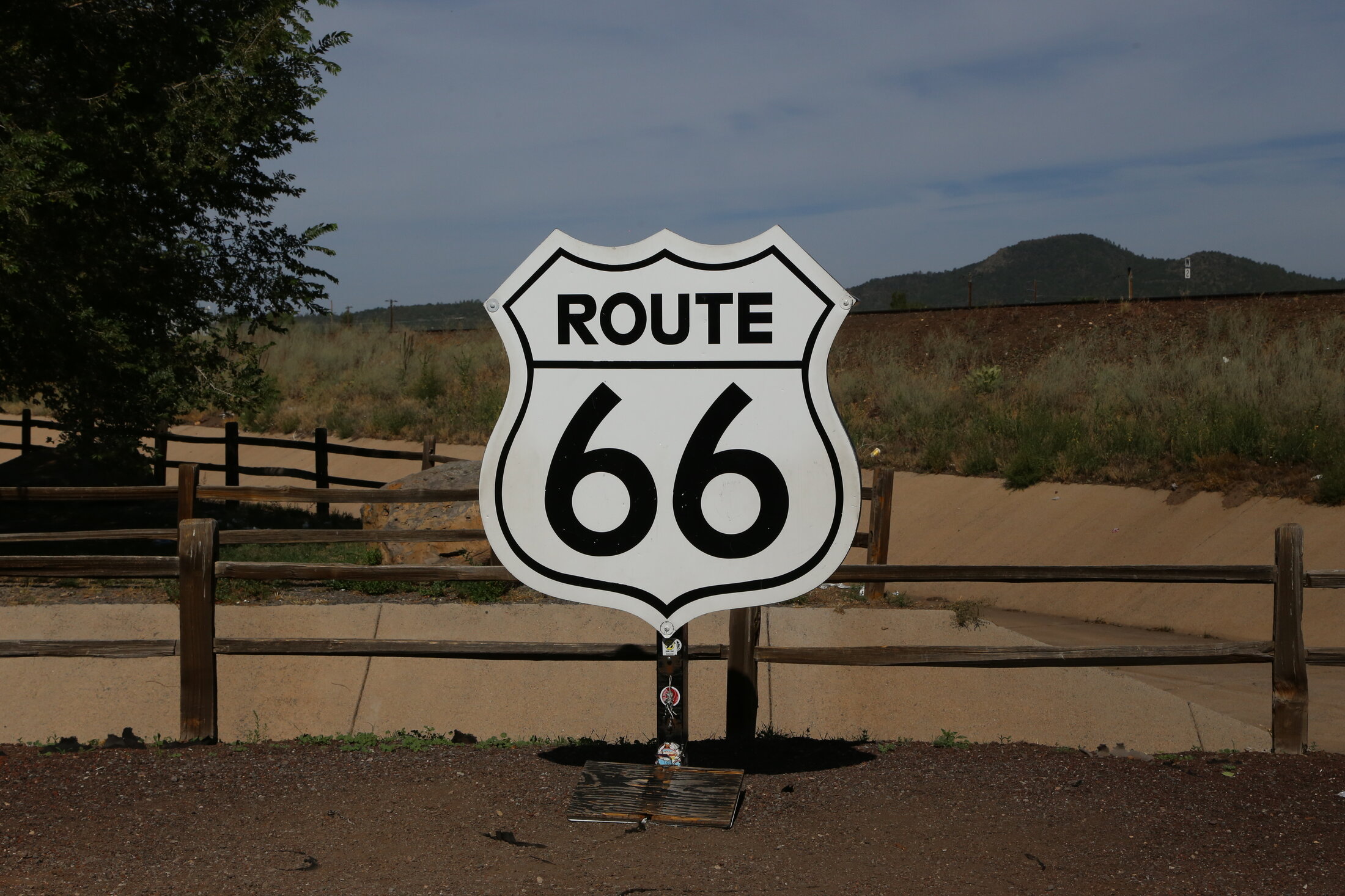 A classic Route 66 shield beneath the wide Arizona sky.
