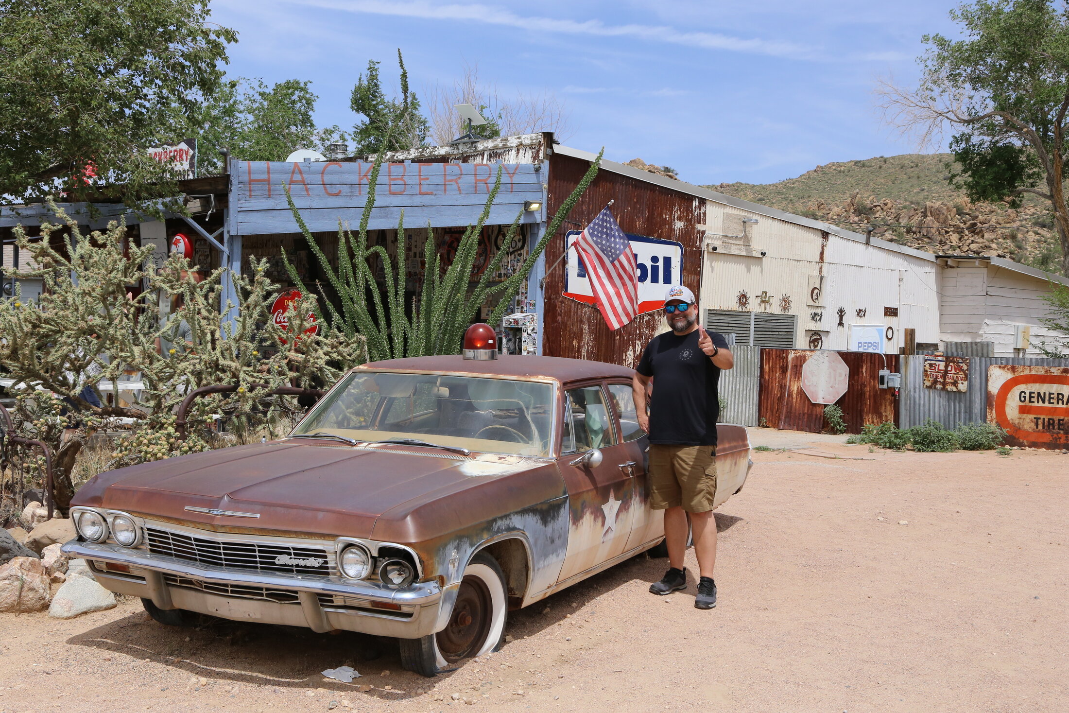 Mike checks out the vintage police car beside the general store.