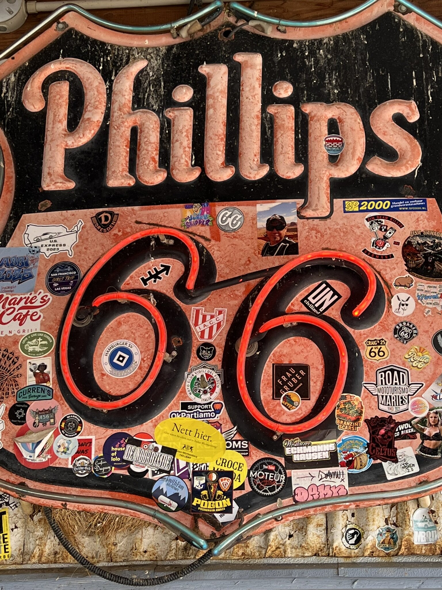 A hand-painted Phillips 66 display surrounded by decades of travelers’ stickers.