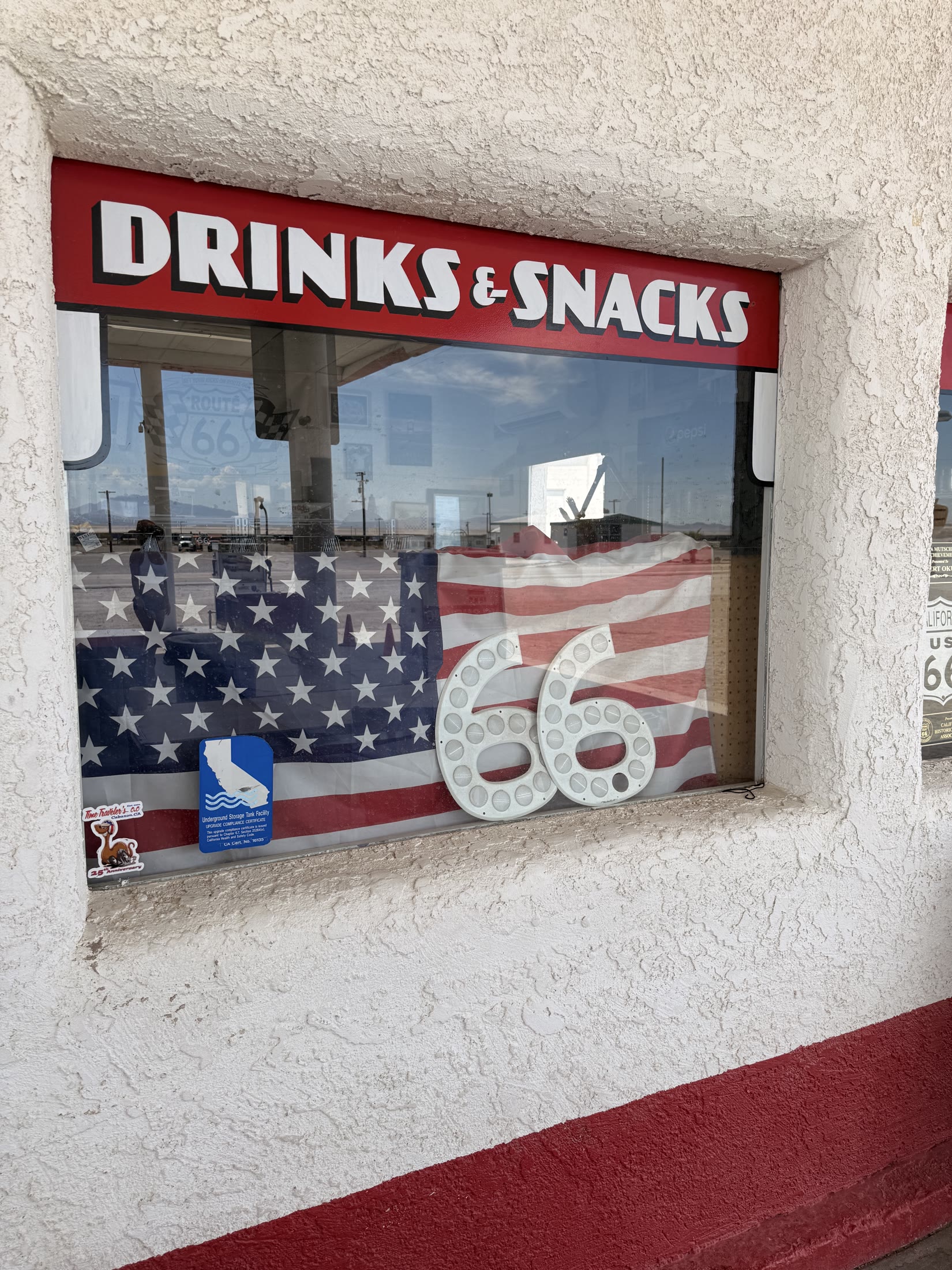 Route 66 memorabilia in the drinks-and-snacks window at Roy’s.