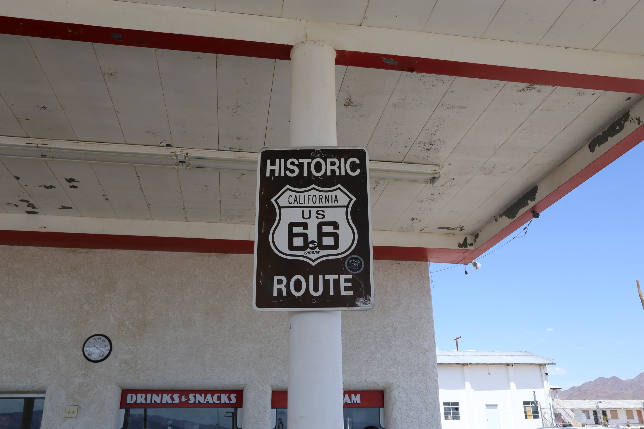 A Historic Route 66 marker hanging beneath the canopy at Roy’s.