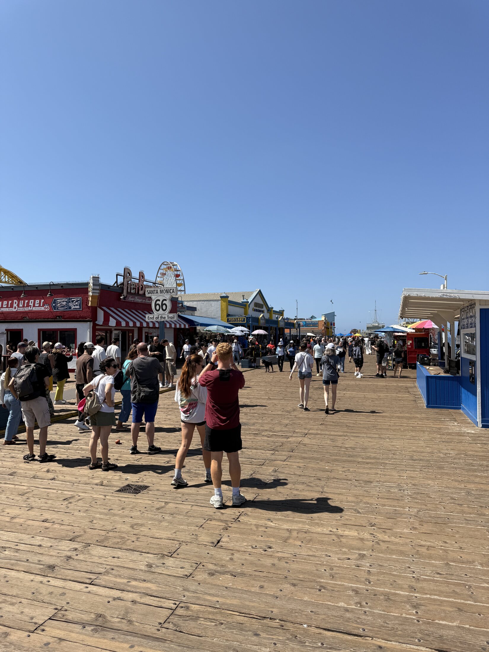 A busy Saturday crowd along the Santa Monica Pier.